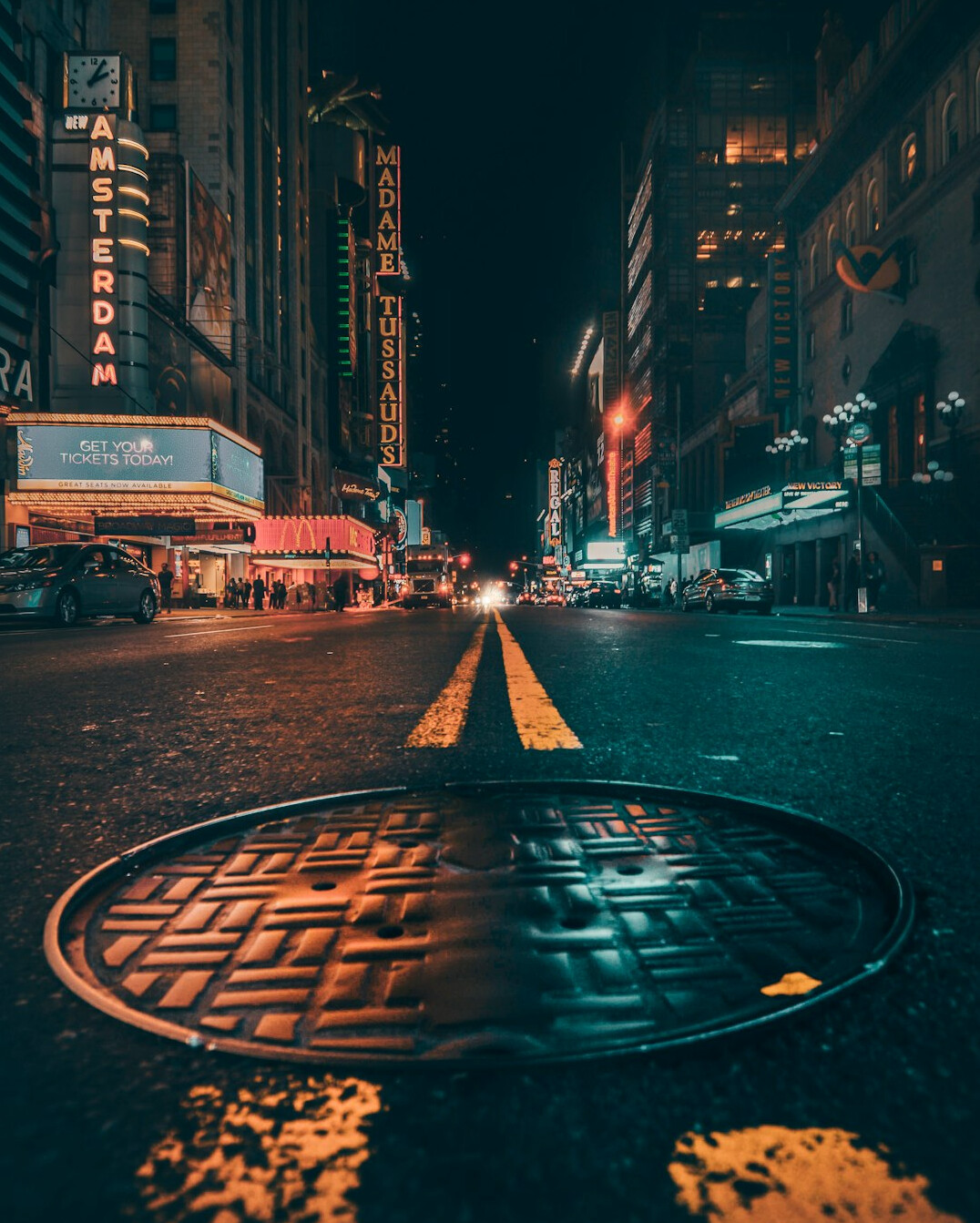 City street at night under city lights, moody atmosphere