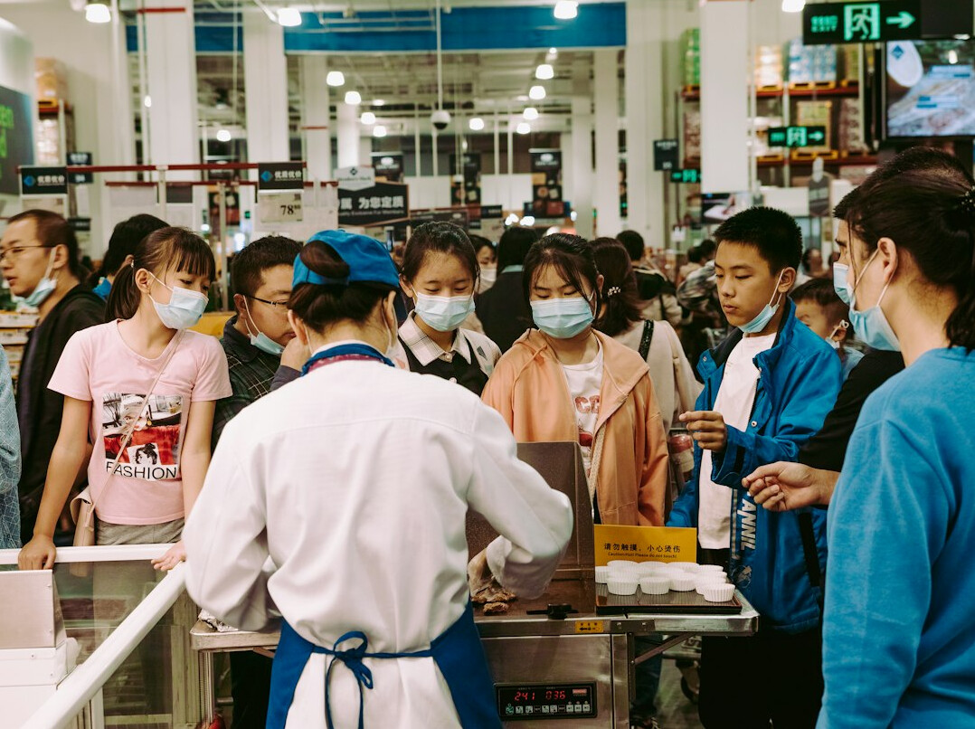 group of shoppers in supermarket